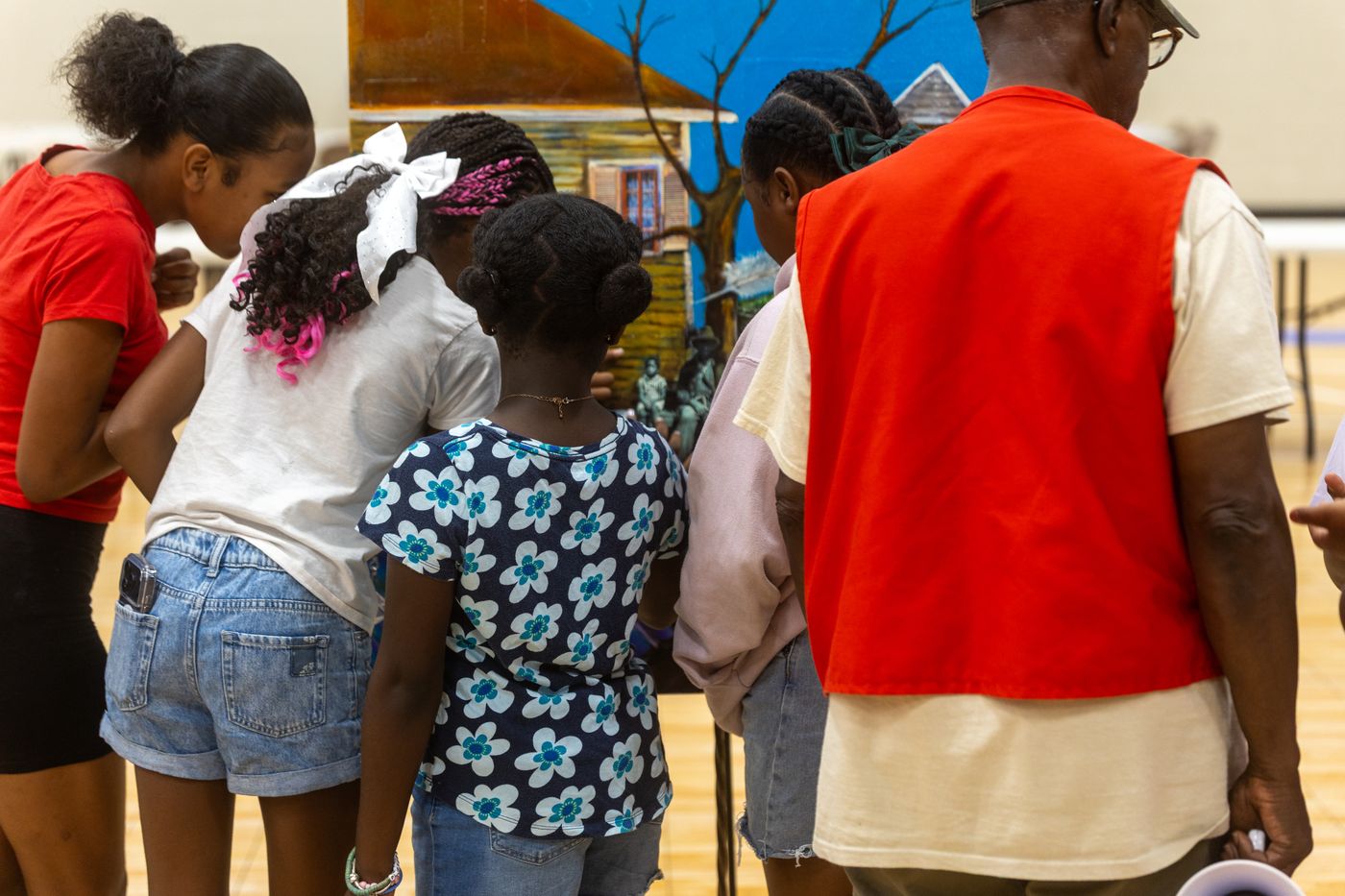 Campers gathered around one of Bryant's canvases